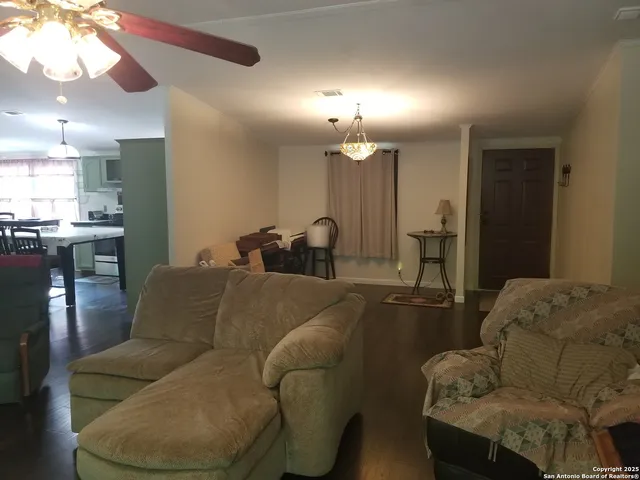 a spacious bedroom with a bed and a chair