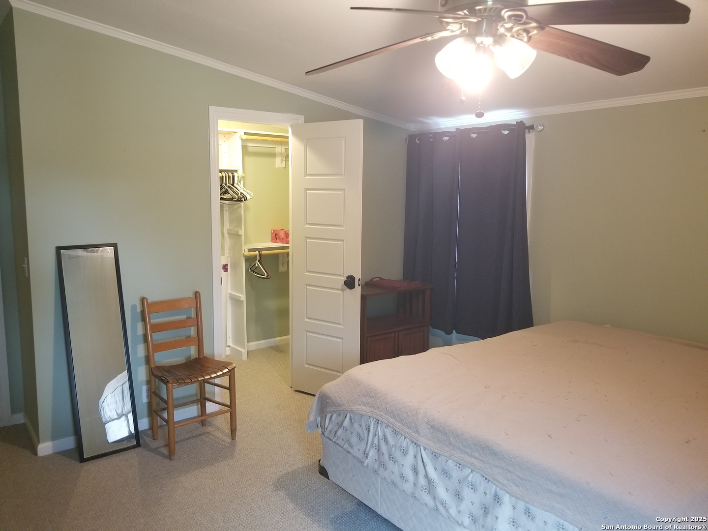 177 Laurel Ridge Drive Lakehills, TX 78063 - Photo 29 of 51 a spacious bedroom with a bed and a chair