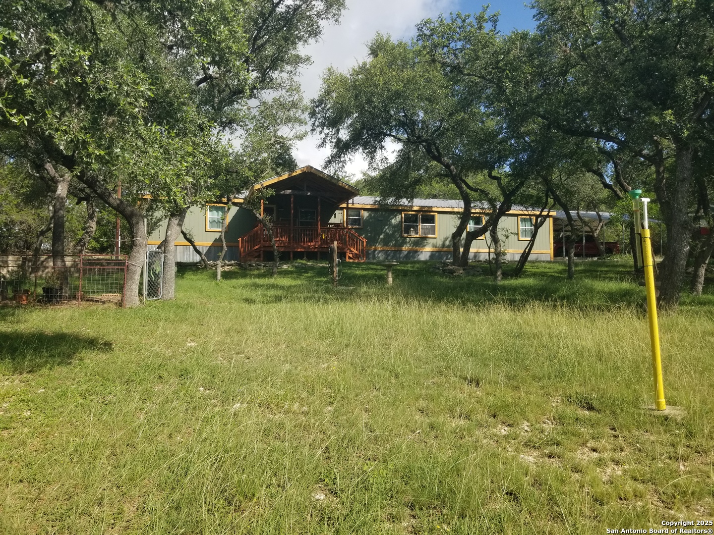 177 Laurel Ridge Drive Lakehills, TX 78063 - Photo 3 of 51 a view of a lake with a building in the background