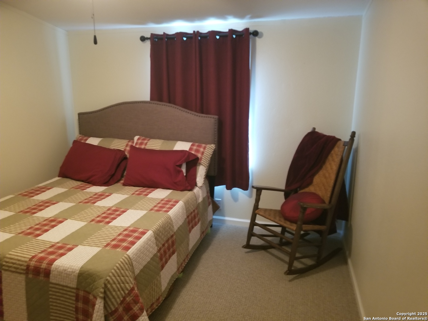 177 Laurel Ridge Drive Lakehills, TX 78063 - Photo 45 of 51 a bedroom with a bed and a chair