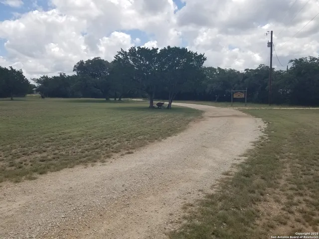 a view of a water fountain and a yard