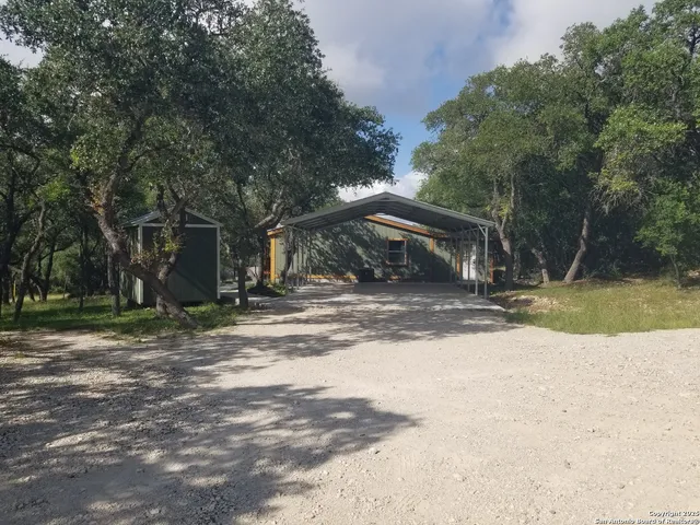 a view of a house with backyard and porch