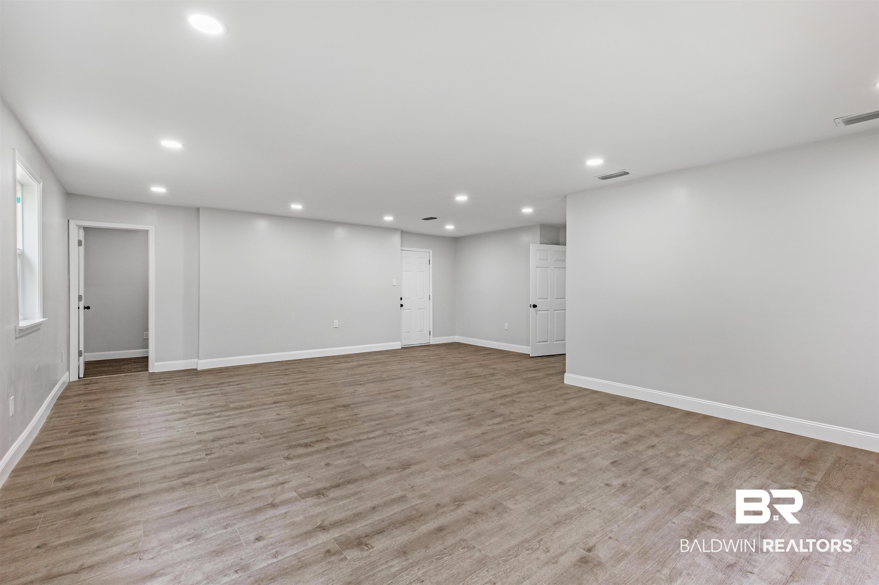 1432 South Polaris Drive Mobile, AL 36693 - Photo 15 of 27 Empty room with recessed lighting and wood finished floors
