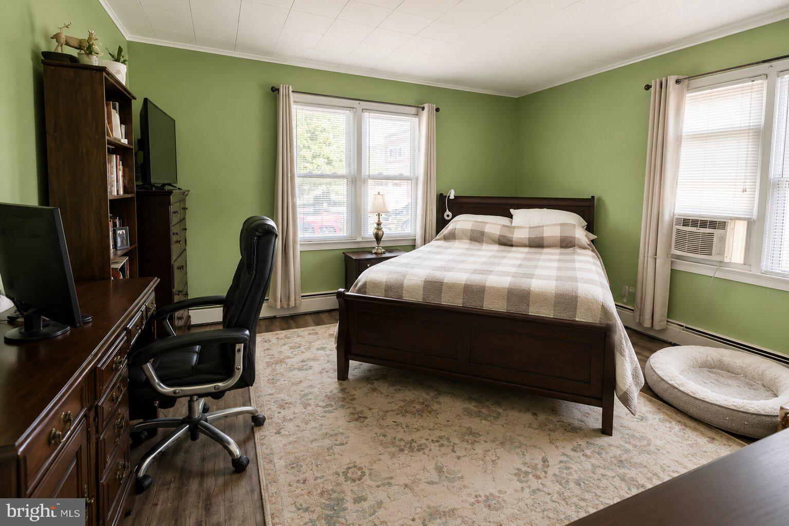 100 Grant Street Riverside, NJ 08075 - Photo 25 of 34 a bedroom with a bed a desk and chair