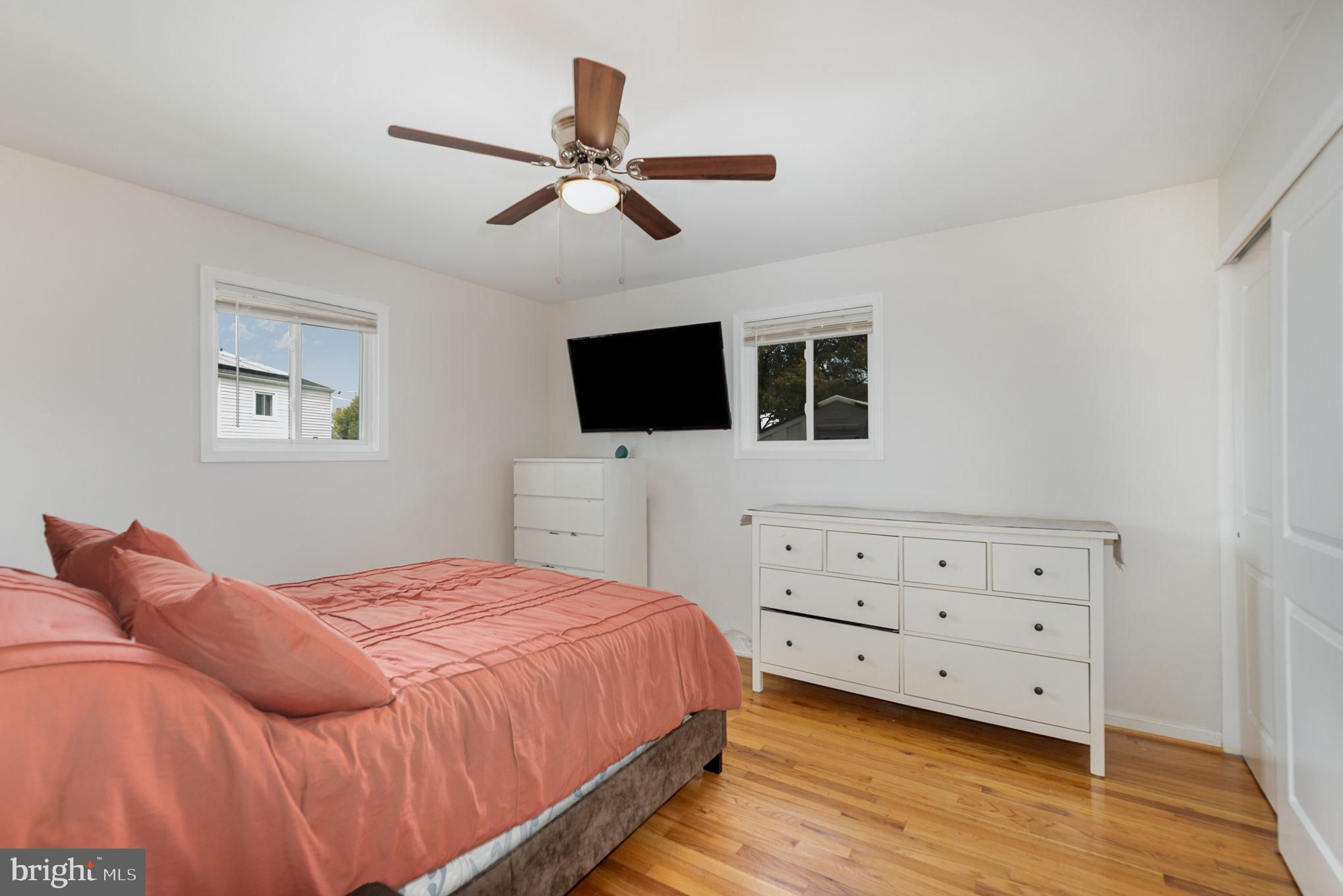 2303 Hamiltowne Circle Rosedale, MD 21237 - Photo 13 of 26 a bedroom with a bed and a flat tv screen on dresser