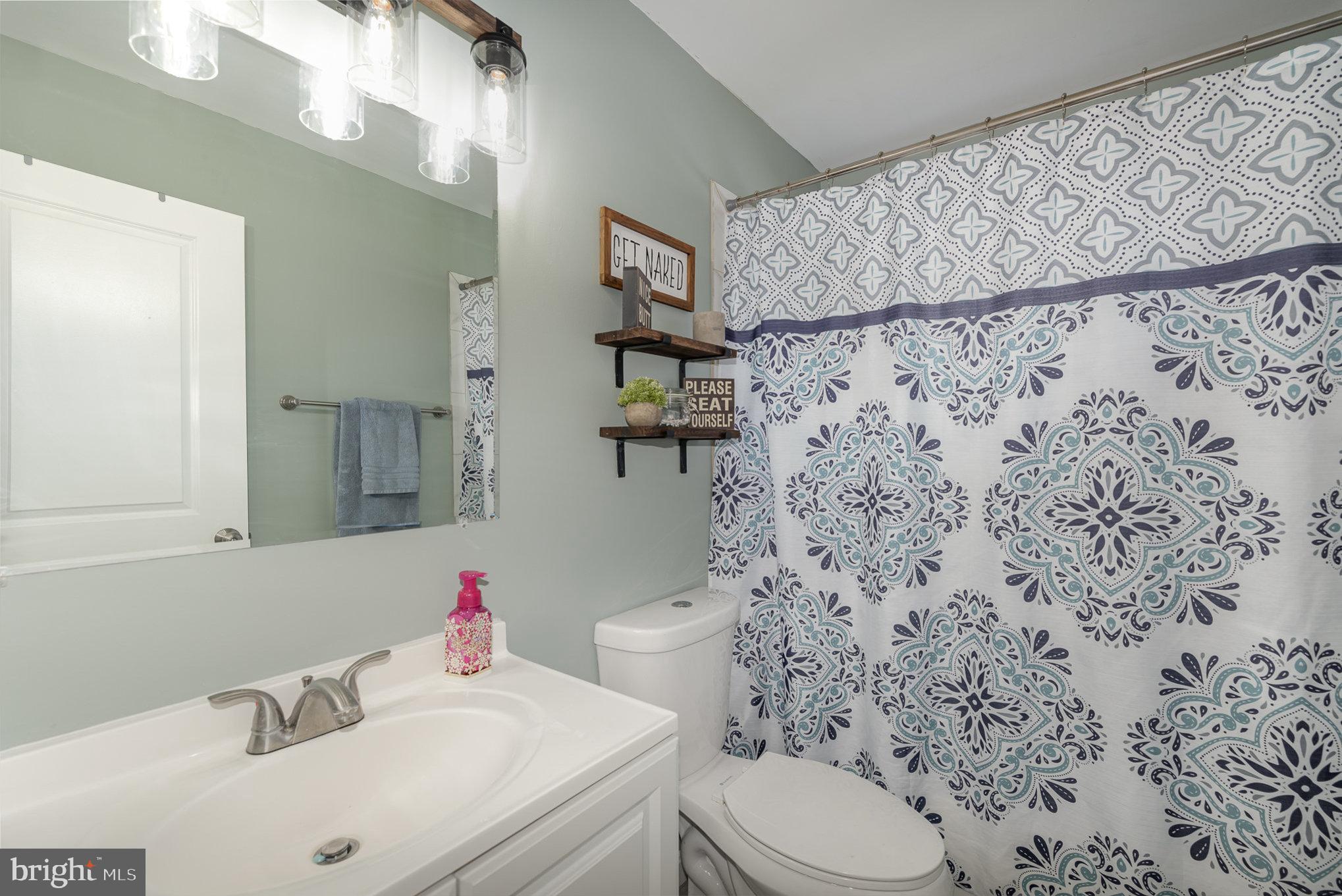 2303 Hamiltowne Circle Rosedale, MD 21237 - Photo 18 of 26 a bathroom with a sink toilet and shower