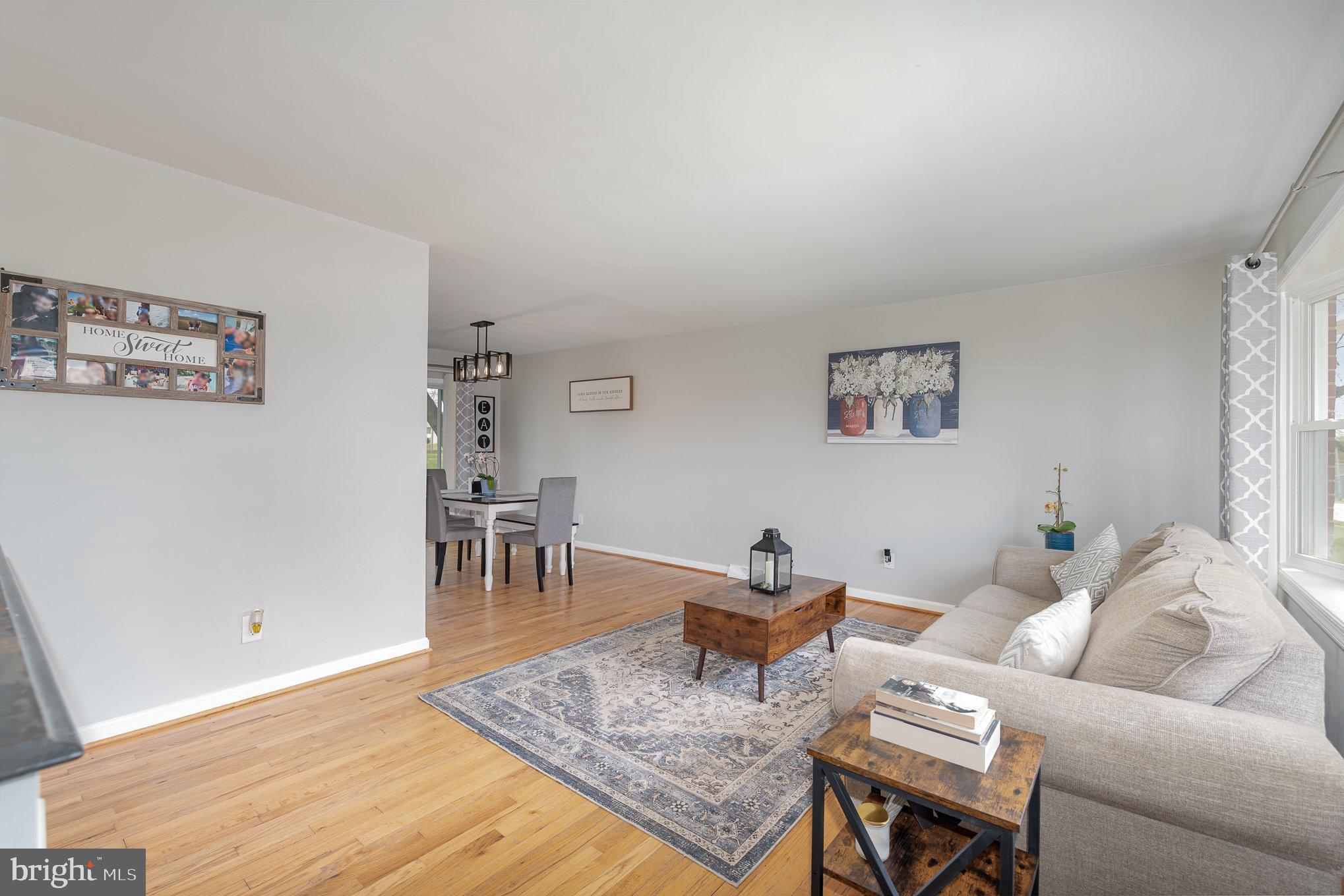 2303 Hamiltowne Circle Rosedale, MD 21237 - Photo 5 of 26 a living room with furniture and a dining table