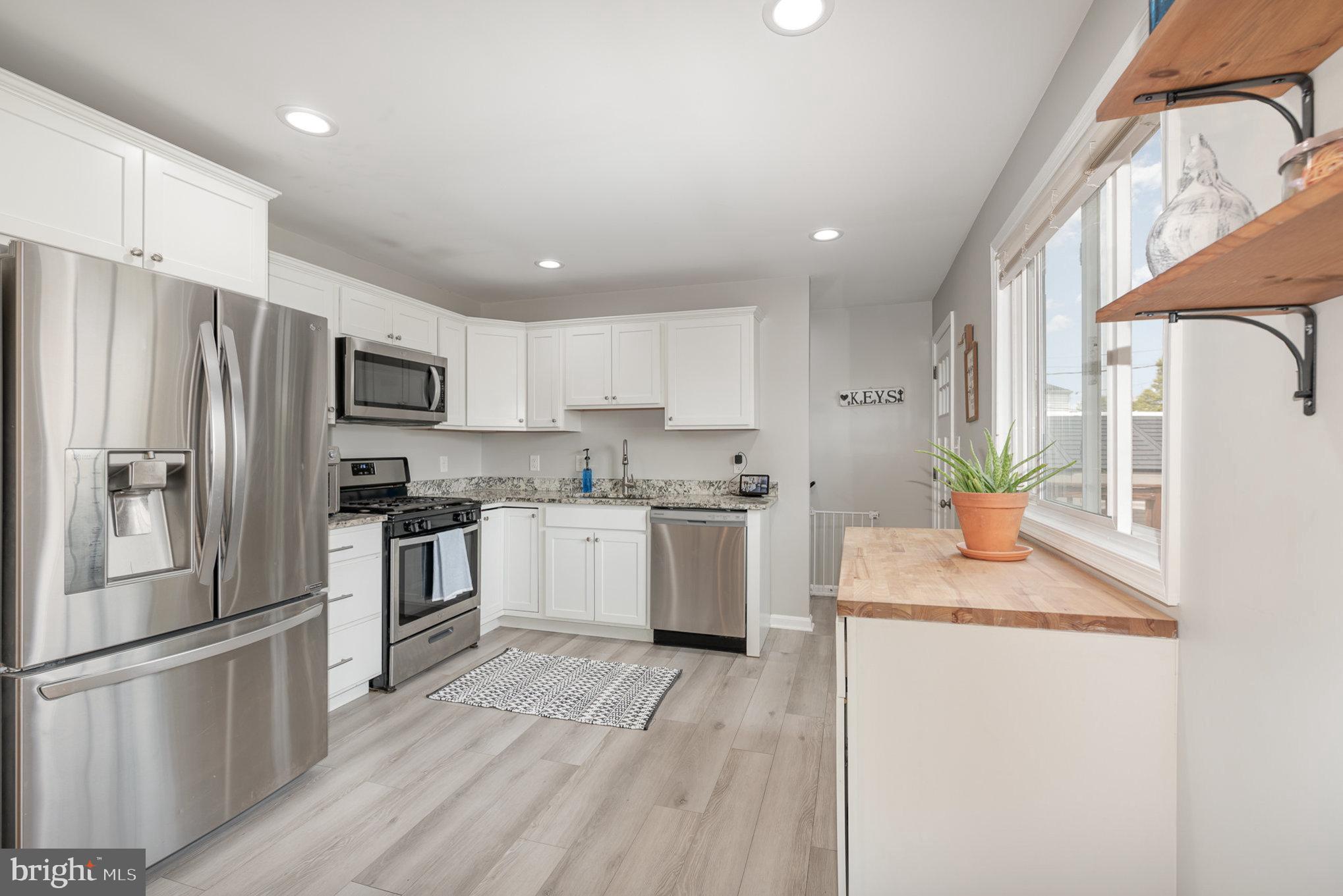 2303 Hamiltowne Circle Rosedale, MD 21237 - Photo 10 of 26 a kitchen with granite countertop a sink stainless steel appliances and cabinets