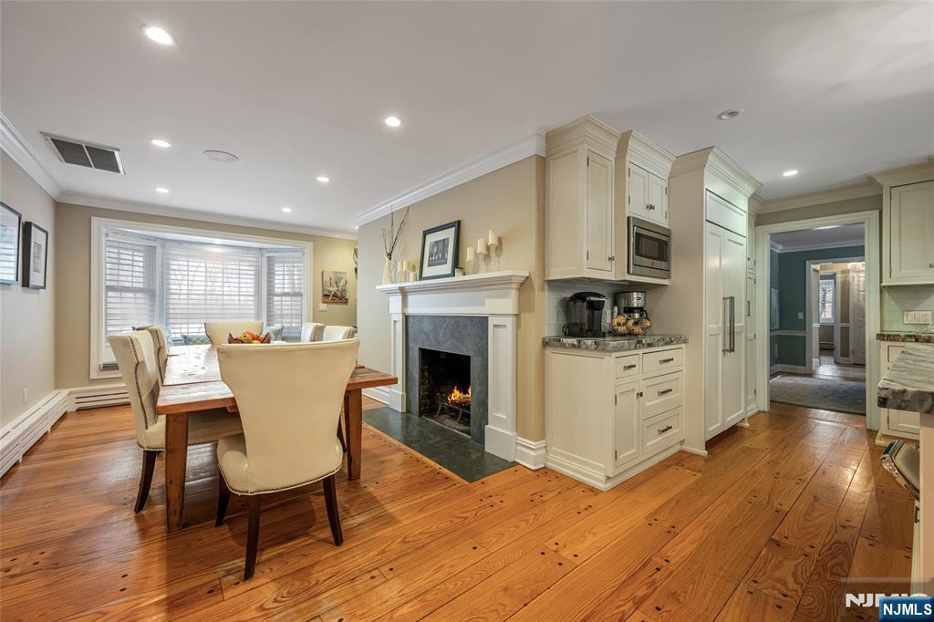 8 White Pine Road Upper Saddle River, NJ 07458 - Photo 22 of 50 a living room with furniture a fireplace and a kitchen view