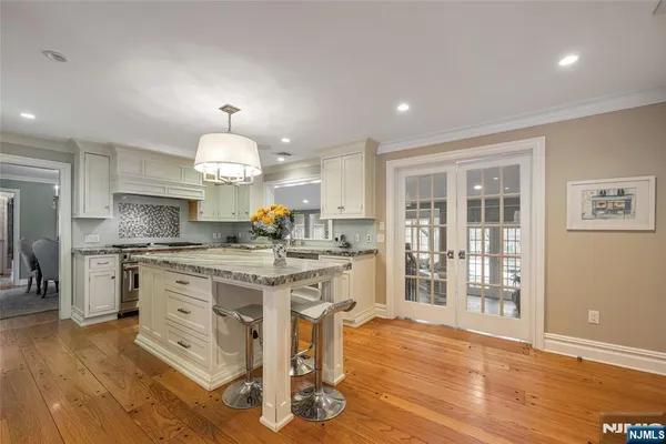 a kitchen with stainless steel appliances granite countertop a stove and a sink