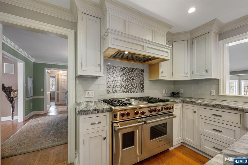 8 White Pine Road Upper Saddle River, NJ 07458 - Photo 25 of 50 a kitchen with stainless steel appliances granite countertop a stove and a sink