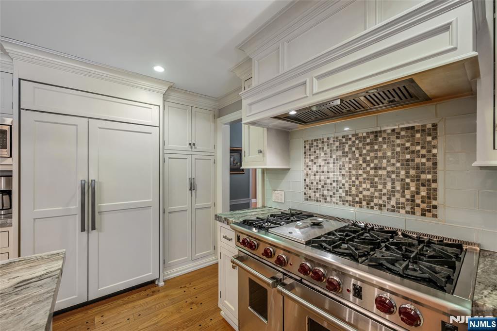 8 White Pine Road Upper Saddle River, NJ 07458 - Photo 27 of 50 a kitchen with wooden cabinets and a stove top oven