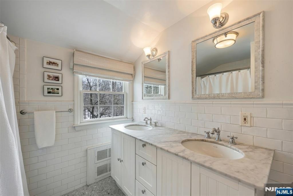 8 White Pine Road Upper Saddle River, NJ 07458 - Photo 32 of 50 a bathroom with a double vanity sink and a mirror