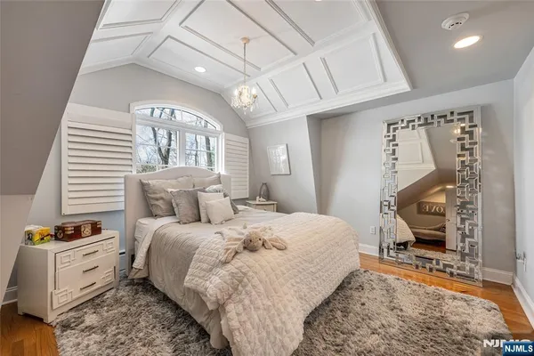 a bedroom with furniture and a wooden floor