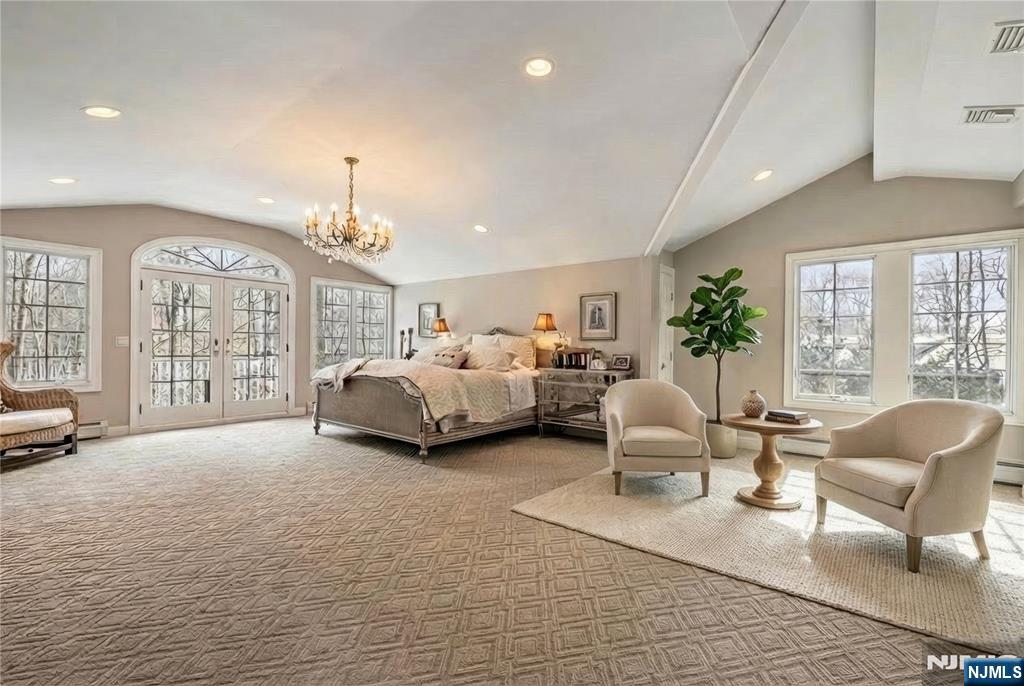 8 White Pine Road Upper Saddle River, NJ 07458 - Photo 38 of 50 a spacious bedroom with a bed a couch and large windows