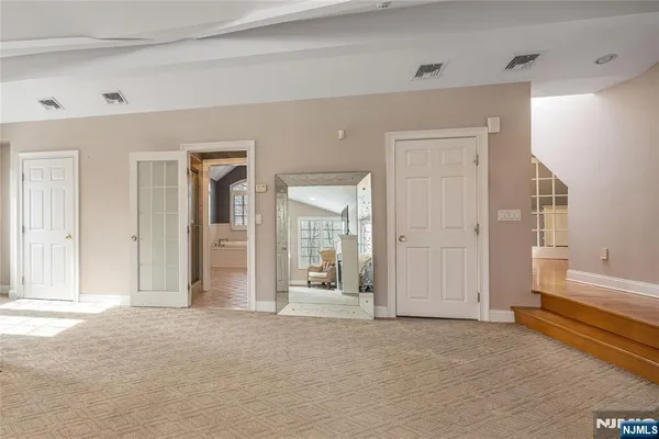 a bathroom with a tub sink and mirror