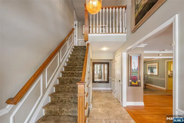 a view of an entryway with wooden floor and windows