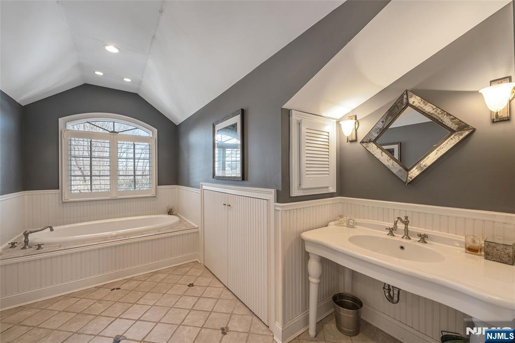 8 White Pine Road Upper Saddle River, NJ 07458 - Photo 42 of 50 a bathroom with a tub sink and mirror