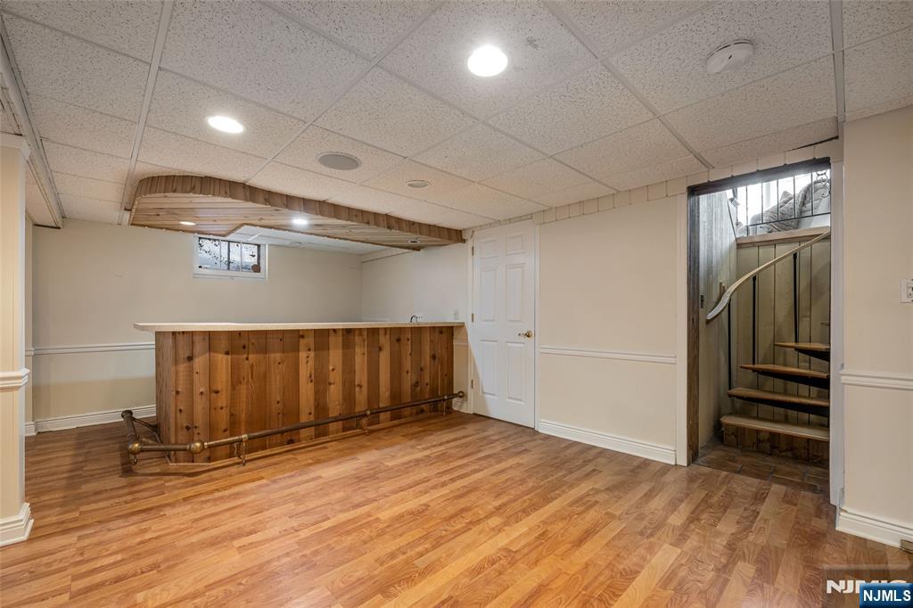 8 White Pine Road Upper Saddle River, NJ 07458 - Photo 44 of 50 an empty room with wooden floor staircase and windows
