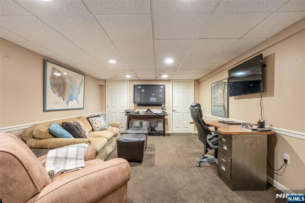 8 White Pine Road Upper Saddle River, NJ 07458 - Photo 46 of 50 a living room with furniture and a flat screen tv