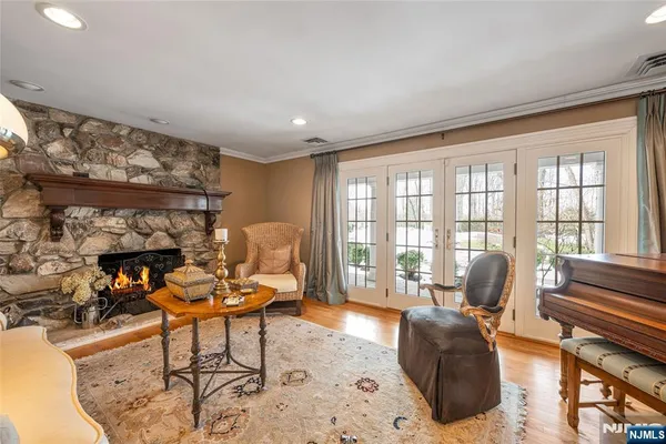 a living room with furniture and a floor to ceiling window