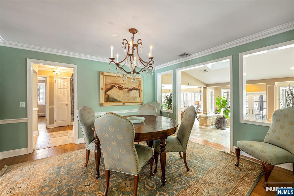 8 White Pine Road Upper Saddle River, NJ 07458 - Photo 10 of 50 a dining room with furniture a chandelier and wooden floor