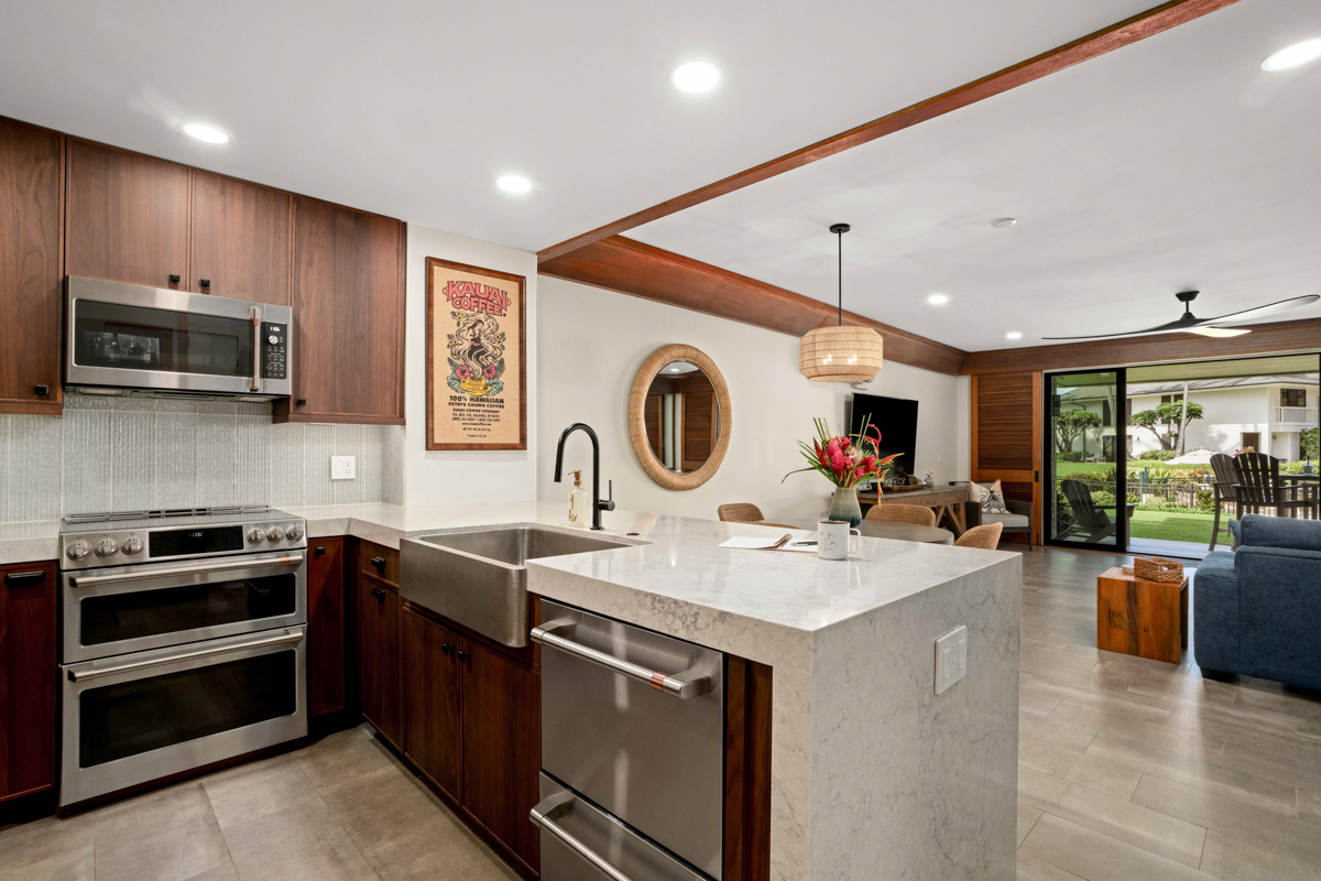 2221 Kapili Road, Unit 45 Koloa, HI 96756 - Photo 6 of 18 a kitchen with sink a microwave and cabinets