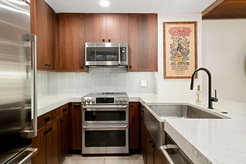 a kitchen with a sink stove and microwave