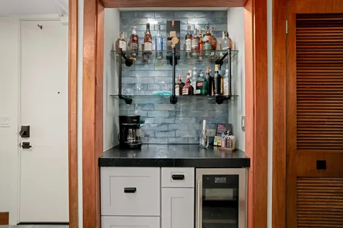 a kitchen with a refrigerator and cabinets