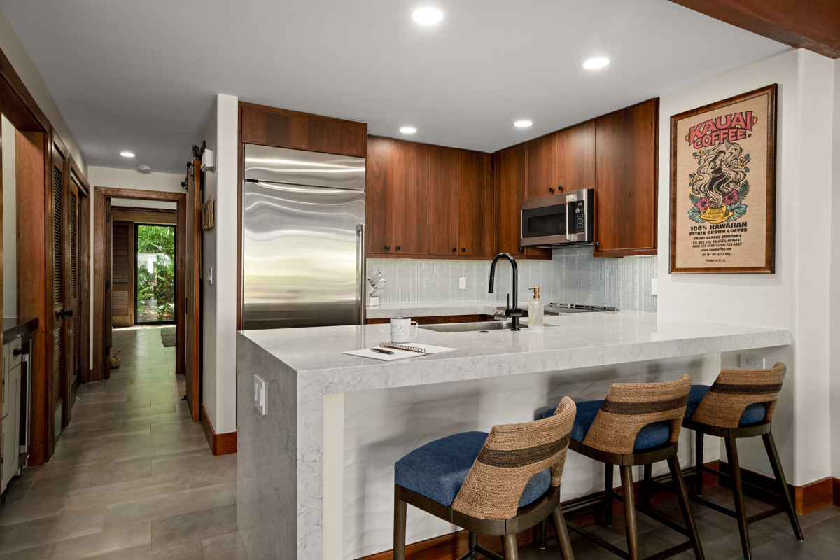 2221 Kapili Road, Unit 45 Koloa, HI 96756 - Photo 10 of 18 a kitchen with kitchen island a sink stove and refrigerator