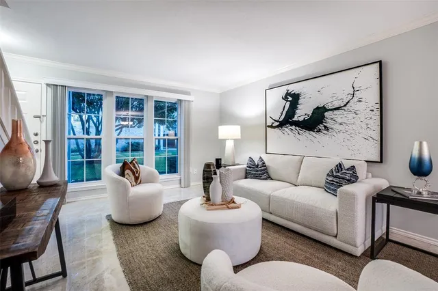 a living room with furniture and floor to ceiling window
