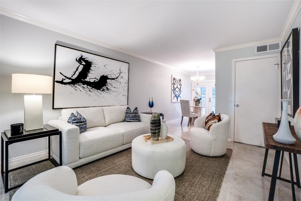 5881 Preston View Boulevard, Unit 159 Dallas, TX 75240 - Photo 3 of 12 a living room with furniture and a lamp
