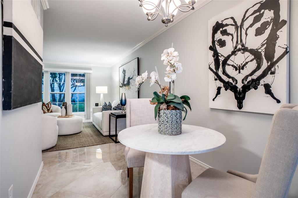 5881 Preston View Boulevard, Unit 159 Dallas, TX 75240 - Photo 5 of 12 a dining room with furniture and wooden floor