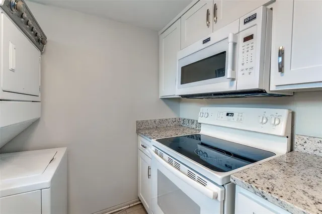 a kitchen with granite countertop cabinets stainless steel appliances and a sink