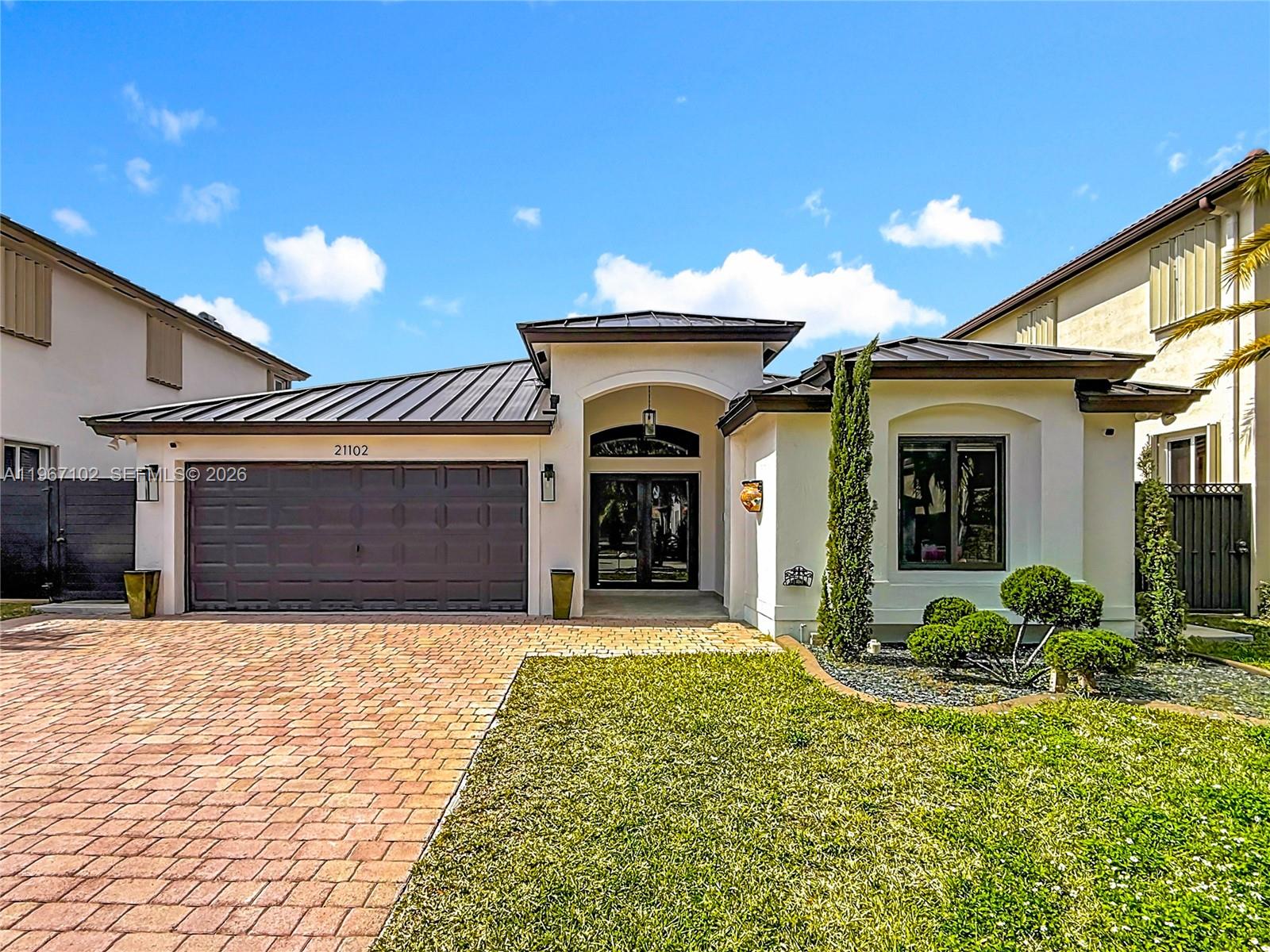 a view of a house with potted plants