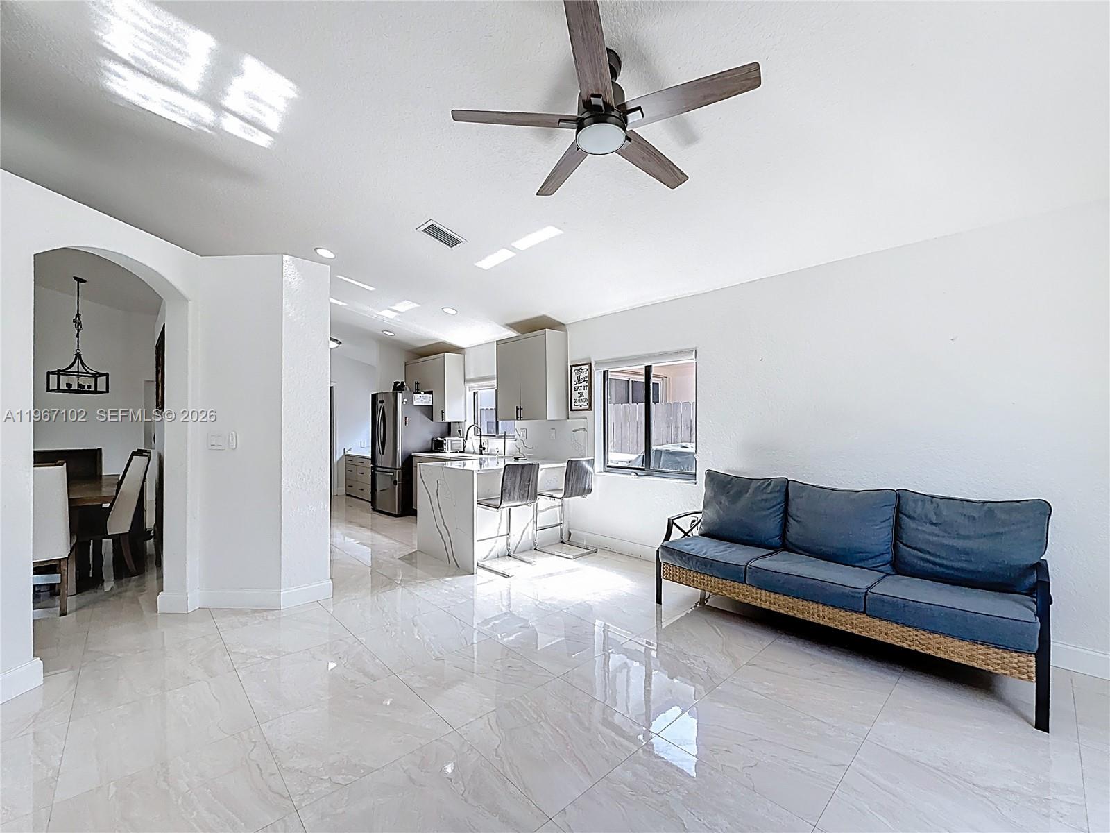 21102 Southwest 92nd Court Cutler Bay, FL 33189 - Photo 14 of 40 a living room with furniture and a ceiling fan