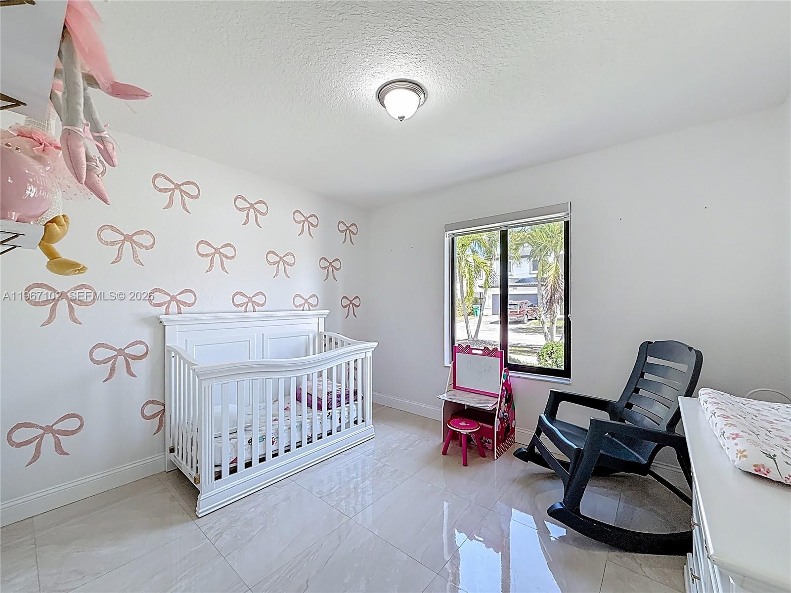 21102 Southwest 92nd Court Cutler Bay, FL 33189 - Photo 16 of 40 a bedroom with furniture and a window