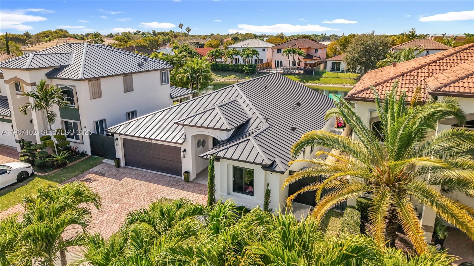 21102 Southwest 92nd Court Cutler Bay, FL 33189 - Photo 2 of 40 a view of a house with a garden and balcony