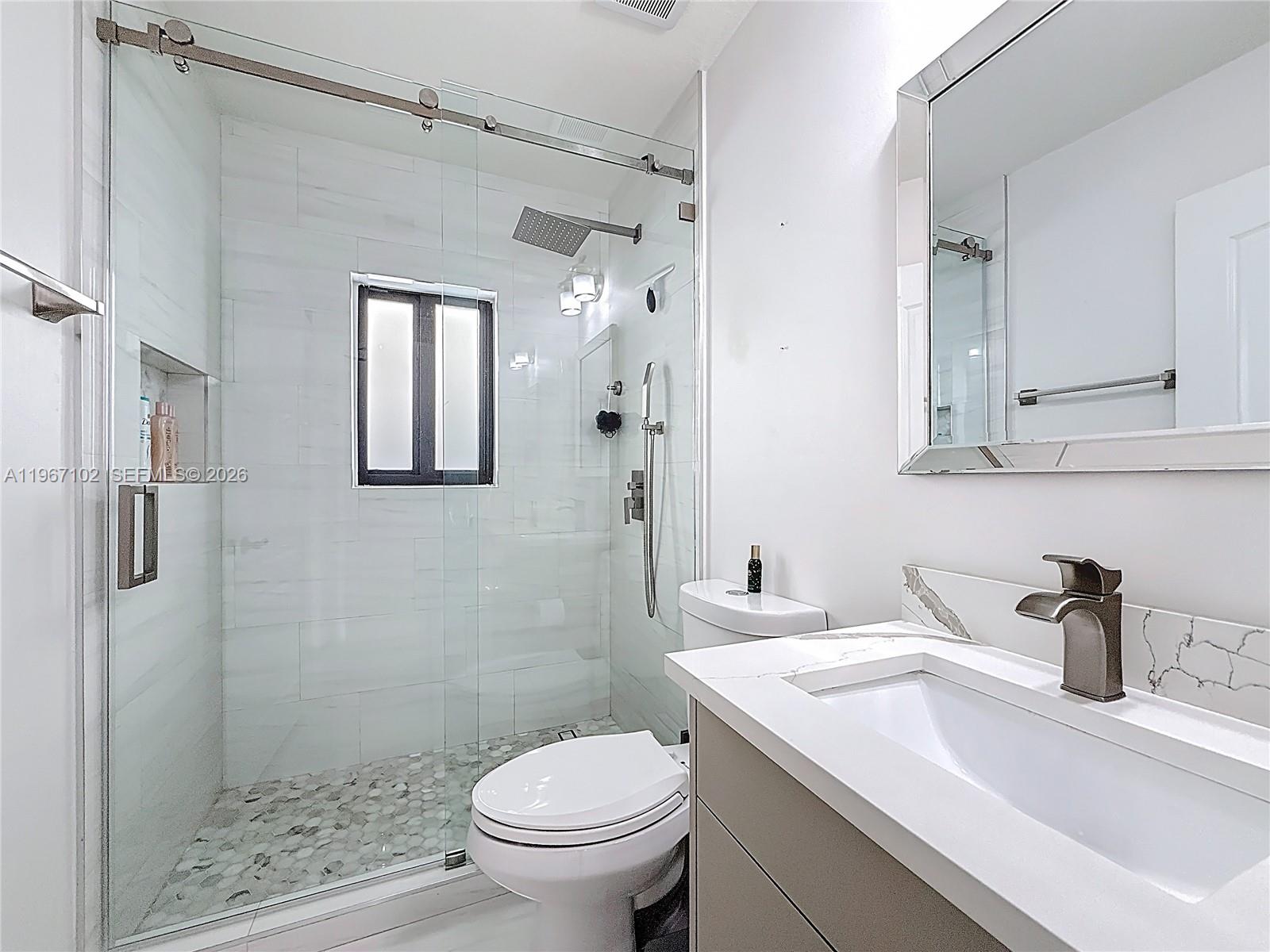 21102 Southwest 92nd Court Cutler Bay, FL 33189 - Photo 21 of 40 a bathroom with a sink toilet and shower