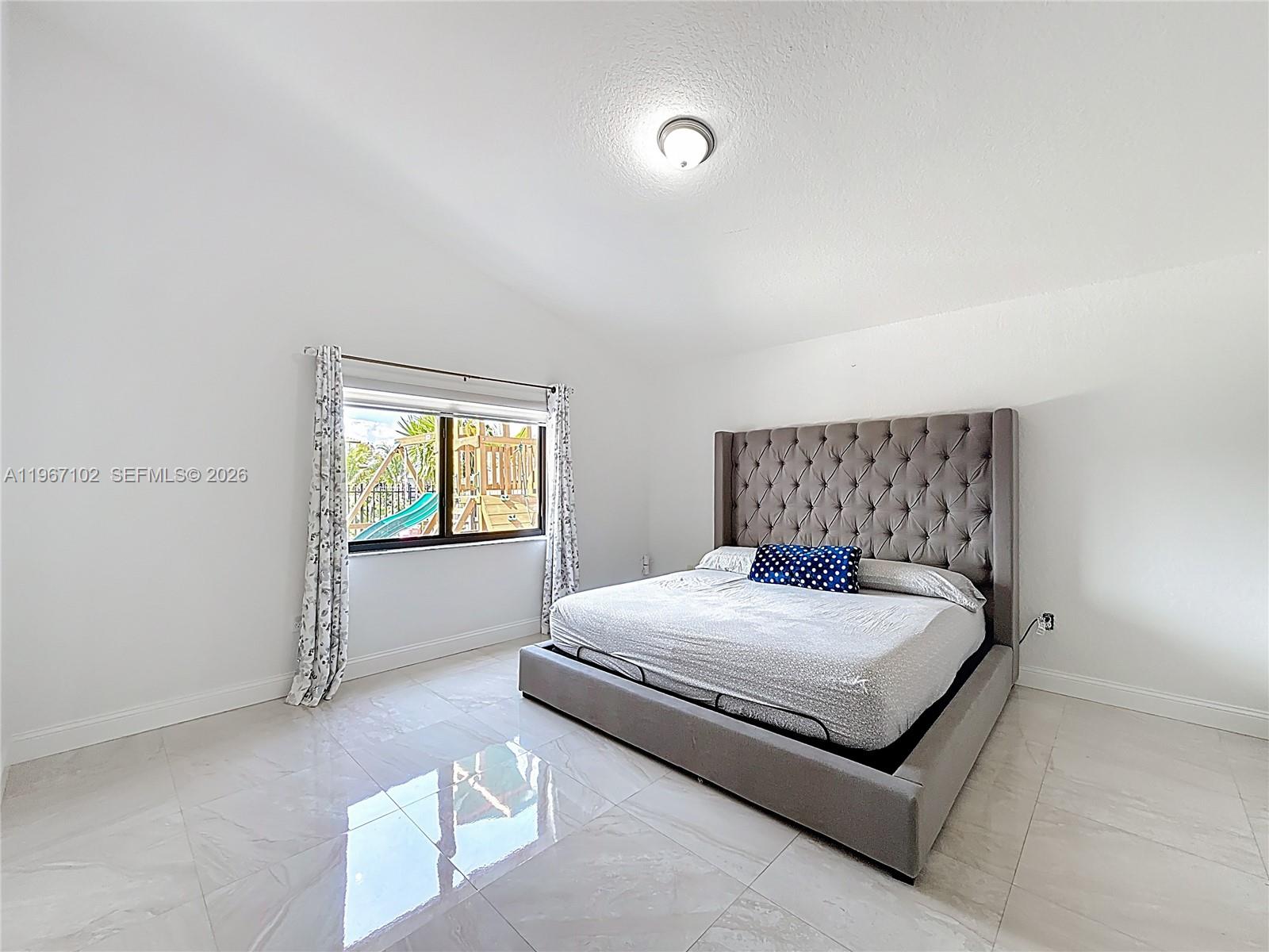 21102 Southwest 92nd Court Cutler Bay, FL 33189 - Photo 23 of 40 a bedroom with a bed and window