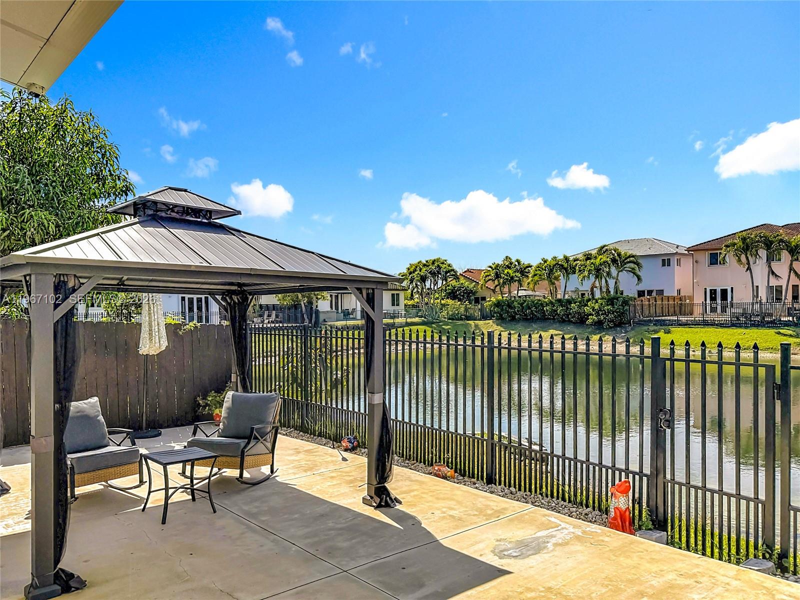 21102 Southwest 92nd Court Cutler Bay, FL 33189 - Photo 31 of 40 a view of a chair and tables in the balcony