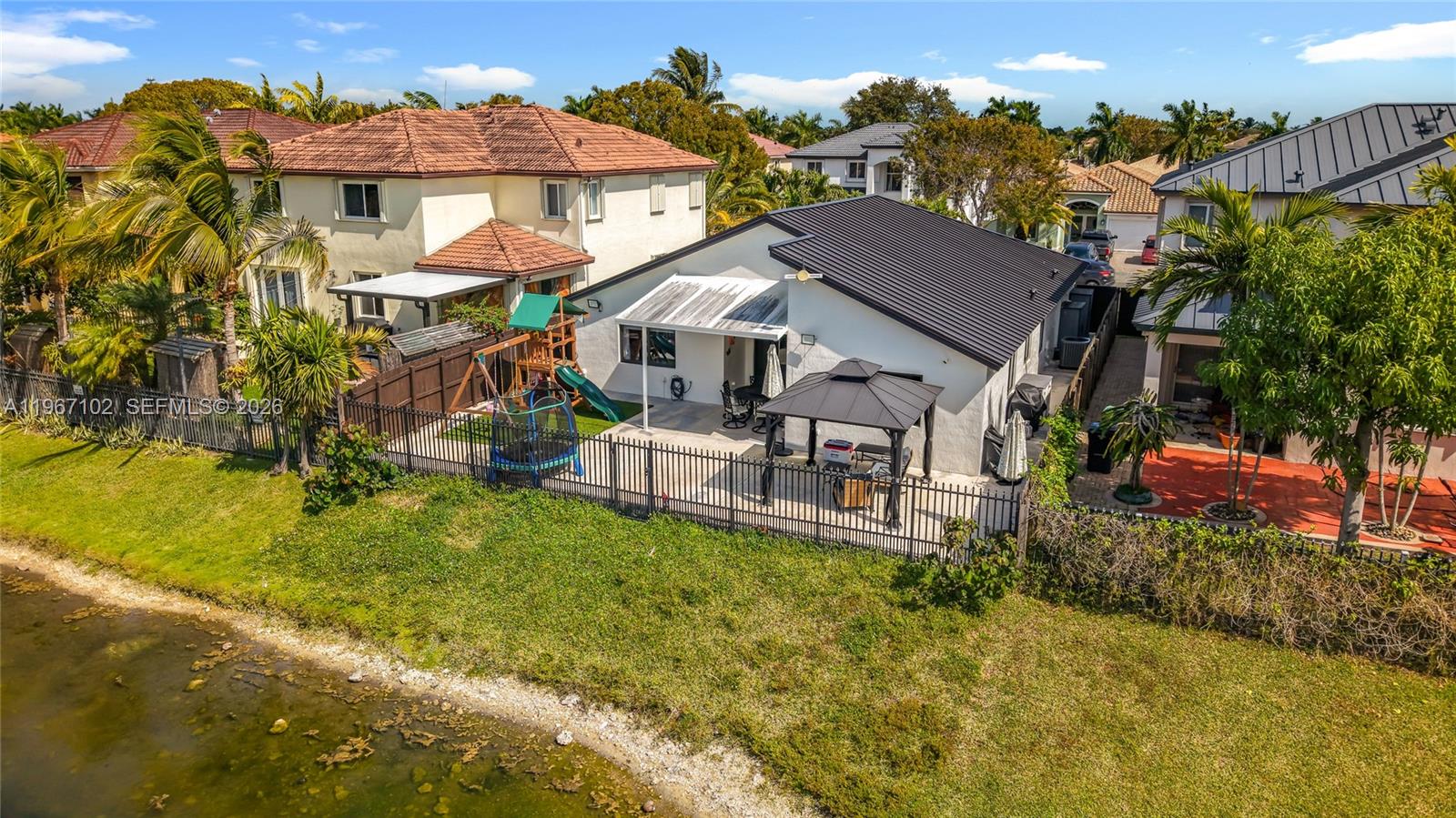 21102 Southwest 92nd Court Cutler Bay, FL 33189 - Photo 35 of 40 a aerial view of a house with a yard table and chairs