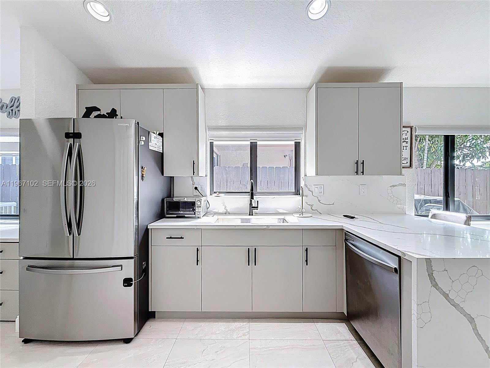 21102 Southwest 92nd Court Cutler Bay, FL 33189 - Photo 8 of 40 a kitchen with stainless steel appliances a refrigerator sink and cabinets