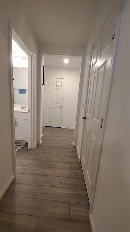 1653 Box Elder Road Forney, TX 75126 - Photo 11 of 21 a view of a hallway with wooden floor and a bathroom