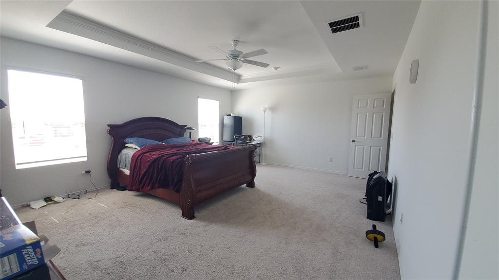 1653 Box Elder Road Forney, TX 75126 - Photo 17 of 21 a bed room with a bed and a chandelier
