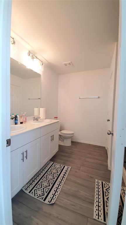 1653 Box Elder Road Forney, TX 75126 - Photo 18 of 21 a bathroom with a sink mirror and toilet
