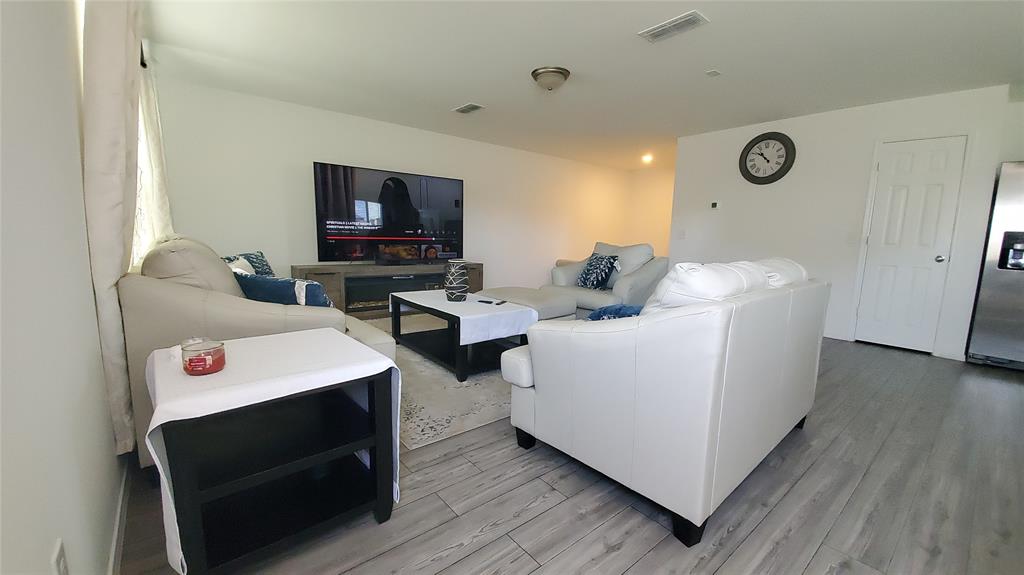 1653 Box Elder Road Forney, TX 75126 - Photo 8 of 21 a living room with furniture and a flat screen tv