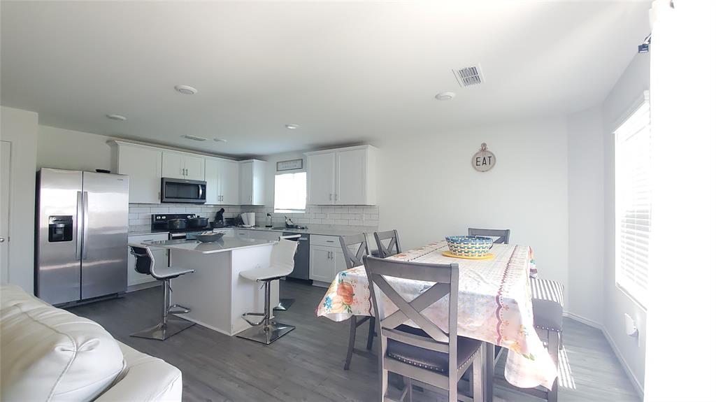 1653 Box Elder Road Forney, TX 75126 - Photo 9 of 21 a view of a dining room with furniture and a kitchen