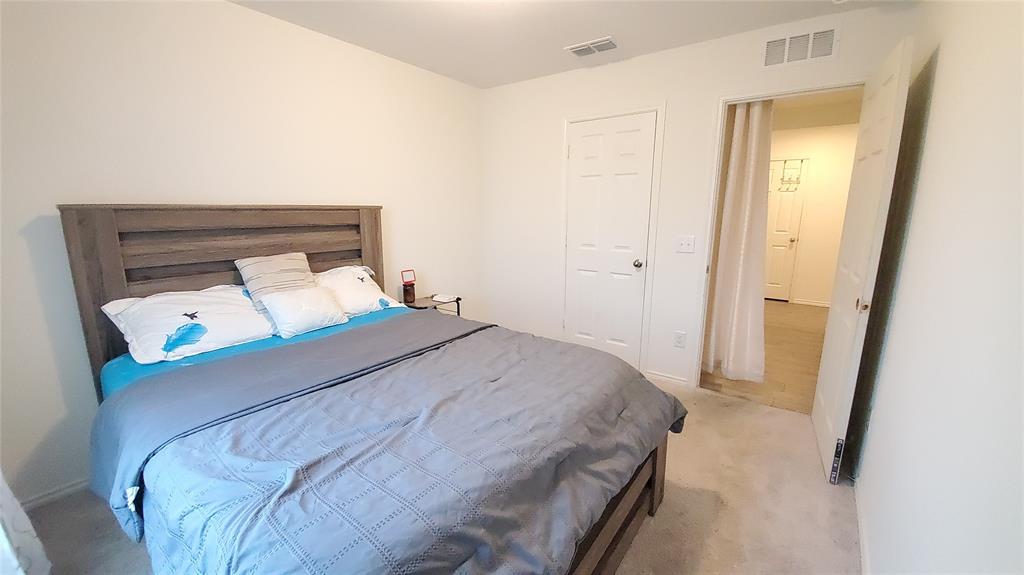 1653 Box Elder Road Forney, TX 75126 - Photo 10 of 21 a bedroom with a bed and a mirror