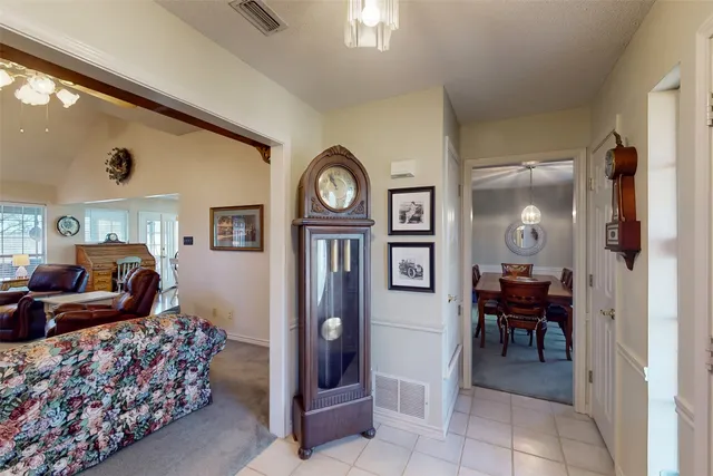a room with wooden floor table and chairs